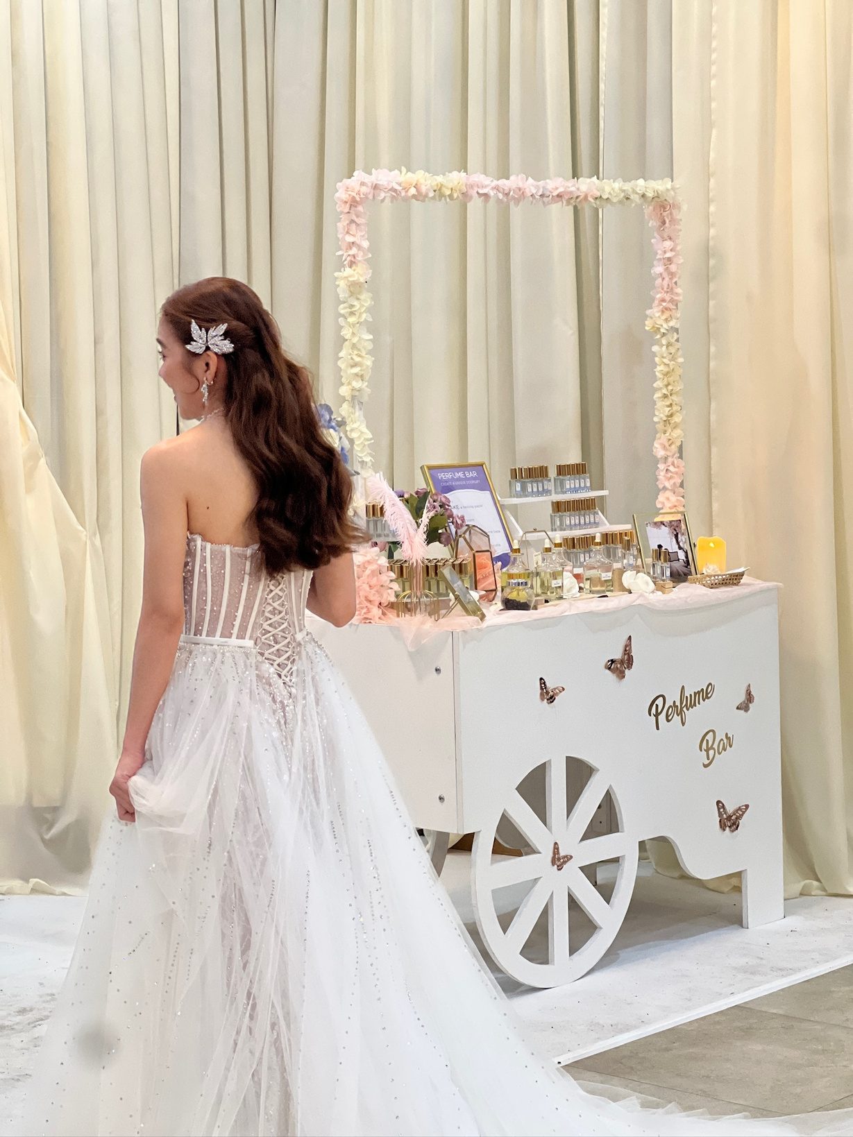 Bride beside a styled Perfume Bar cart