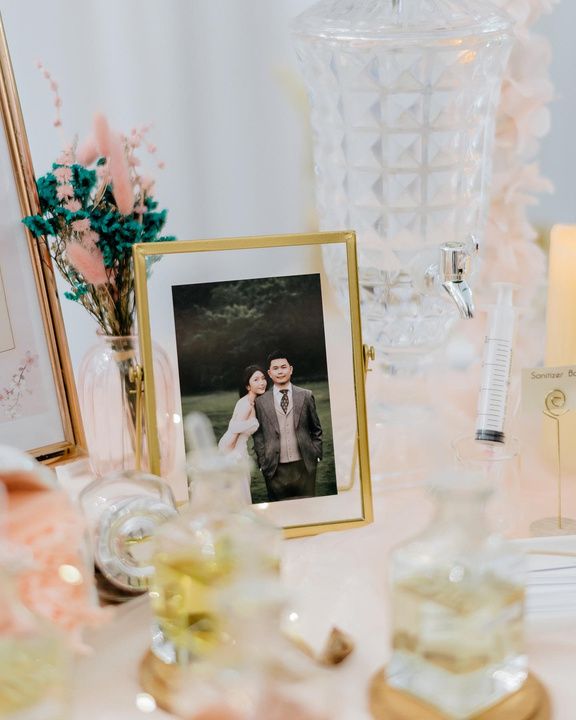 Framed couple photo beside perfume bottles