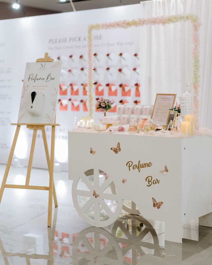 Perfume Bar cart with floral arch