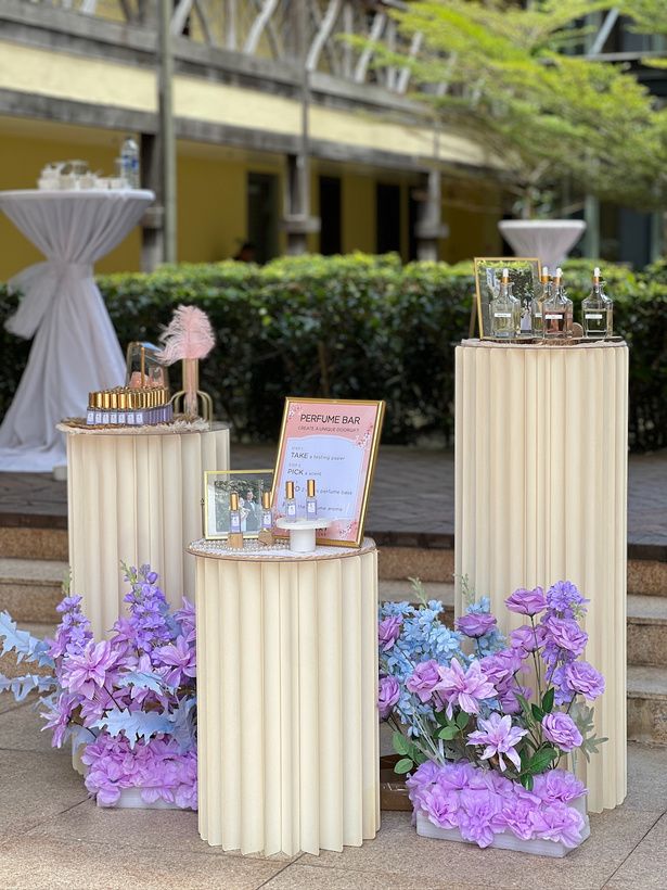 Perfume Bar on pillar stands with flowers