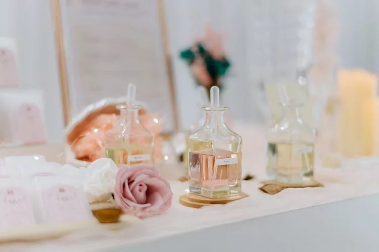 Perfume bottles and roses on a Perfume Bar table